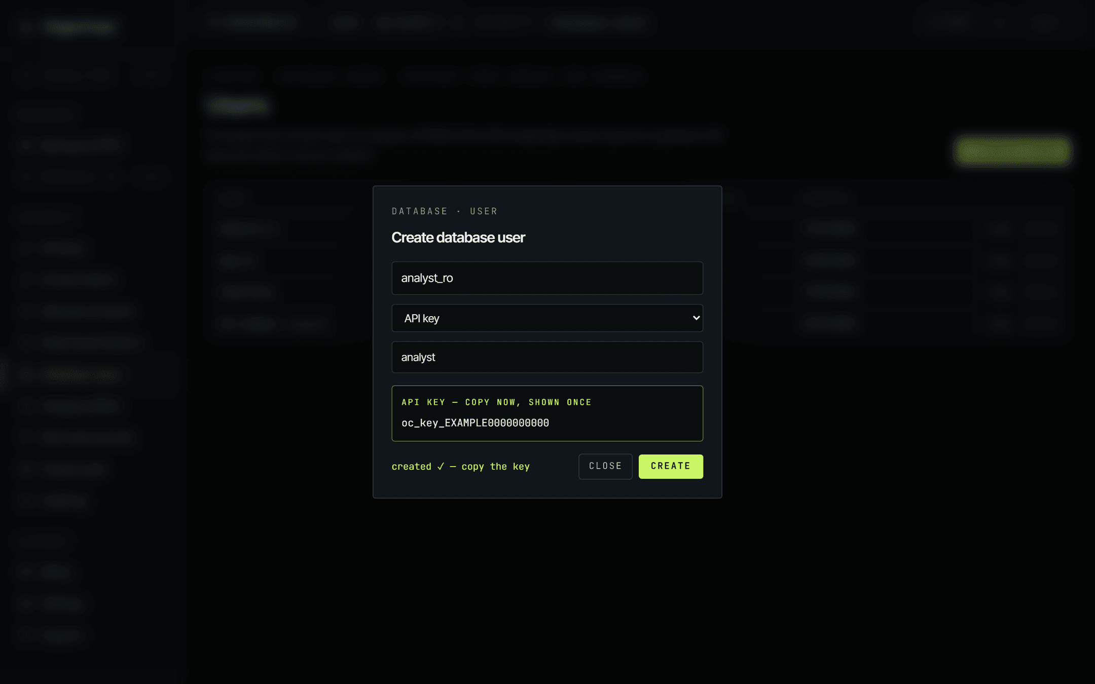 The same dialog after creating the user. A highlighted panel reads API key, copy now, shown once, above an example key value of oc_key_EXAMPLE0000000000, with a created confirmation beneath it.